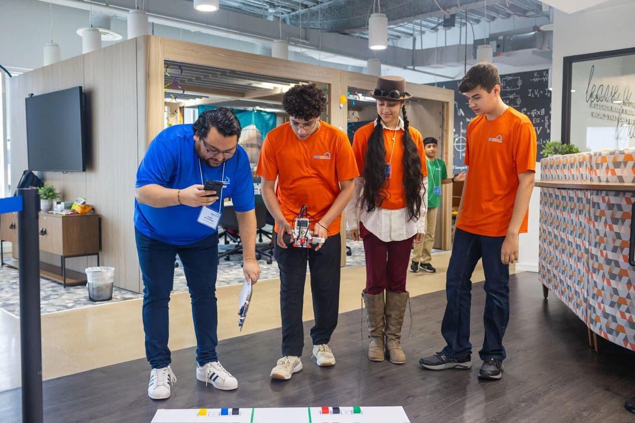 A K12 judge tests the robot's color sensor calibration before the scored run.